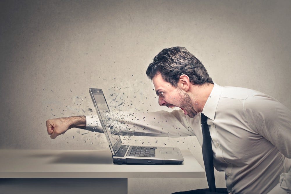 Man in white shirt and tie punching laptop screen.